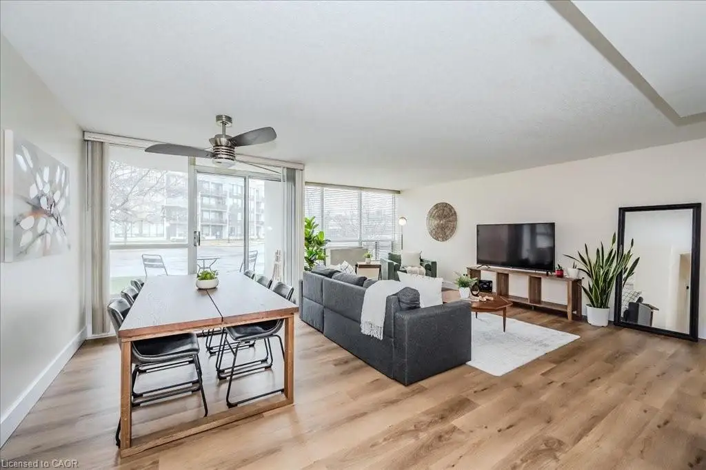 Living room with ceiling fan and light wood-style flooring
