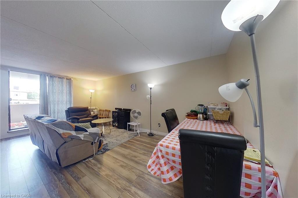 Open concept living area featuring wood-finish flooring and light neutral wall tones