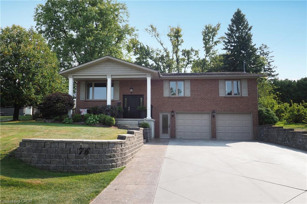 Brick exterior with a covered front entry, two-car garage, and concrete driveway