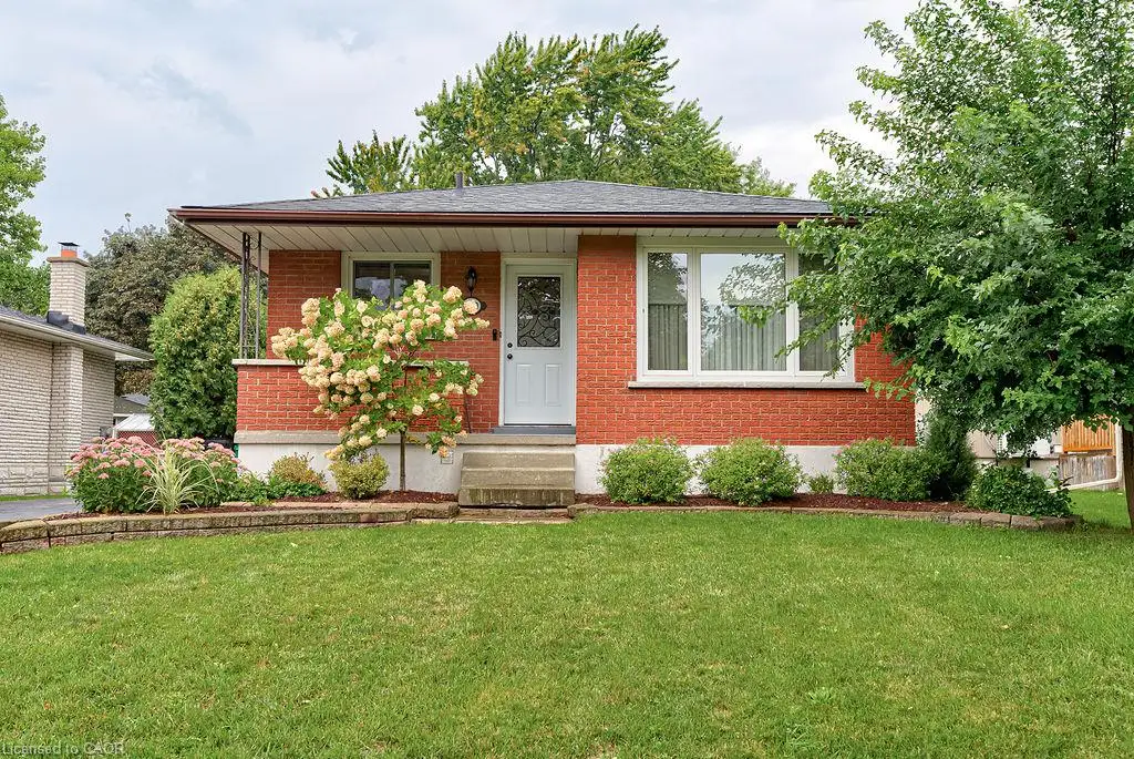Brick exterior with a covered front porch and mature landscaping