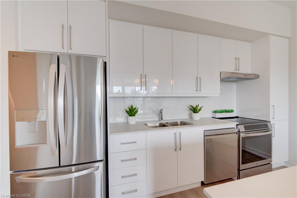 Modern kitchen featuring white cabinetry, a stainless steel refrigerator, a stainless steel dishwasher, a stainless steel range, and a dual basin sink