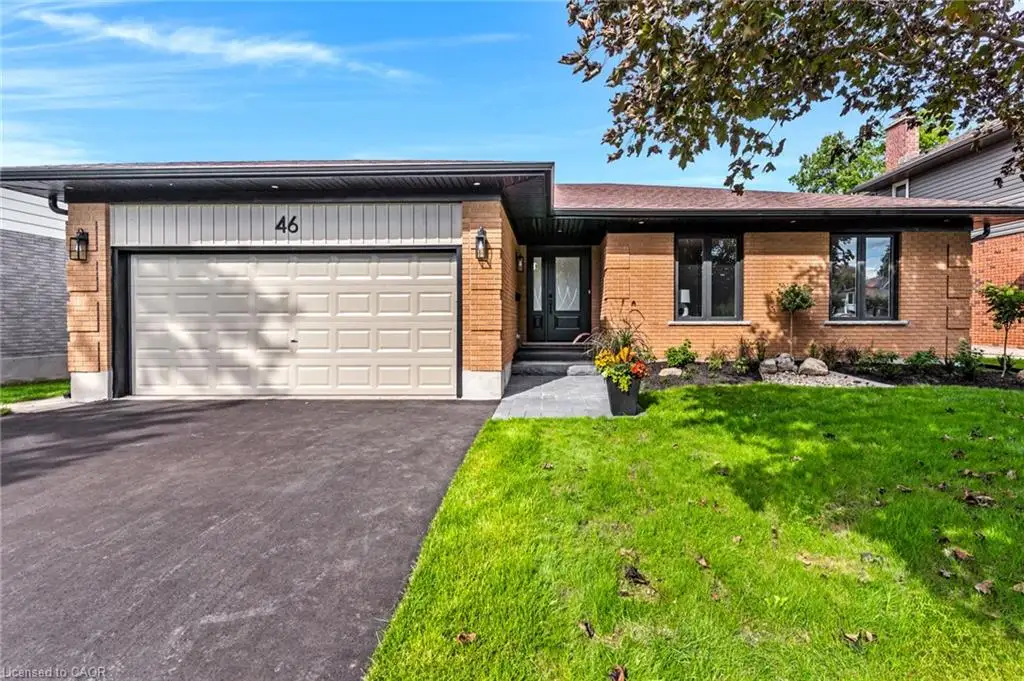 Brick exterior with dark trim windows, single garage with panel detailing, and a paved driveway