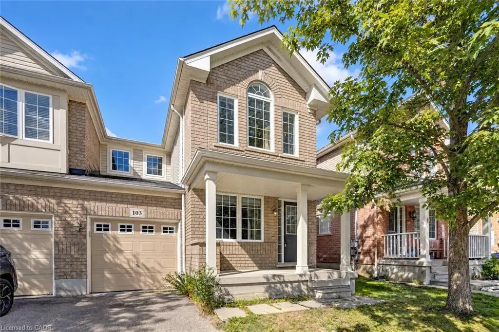 Brick facade with covered porch, arched window, and attached garage