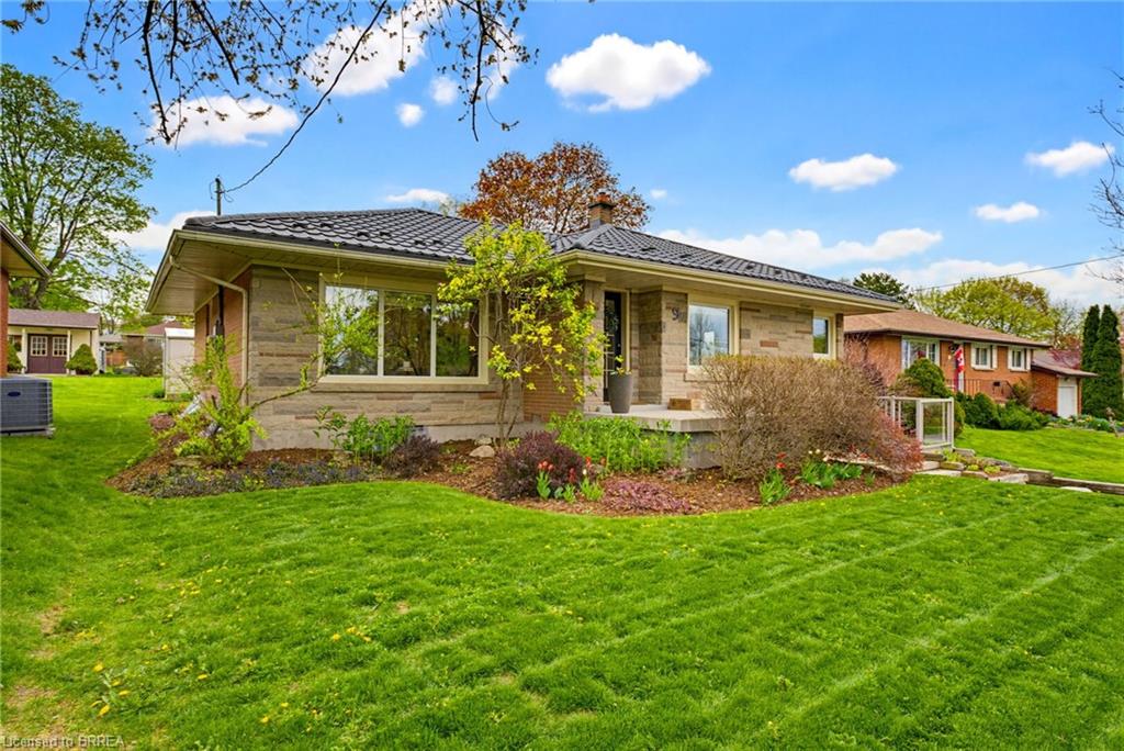 Stone veneer exterior with a dark-toned metal roof