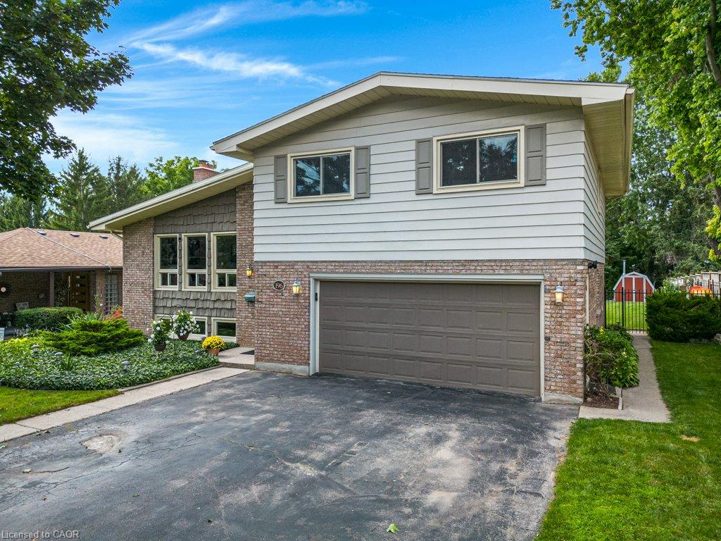 Brick and siding exterior featuring a two-car garage