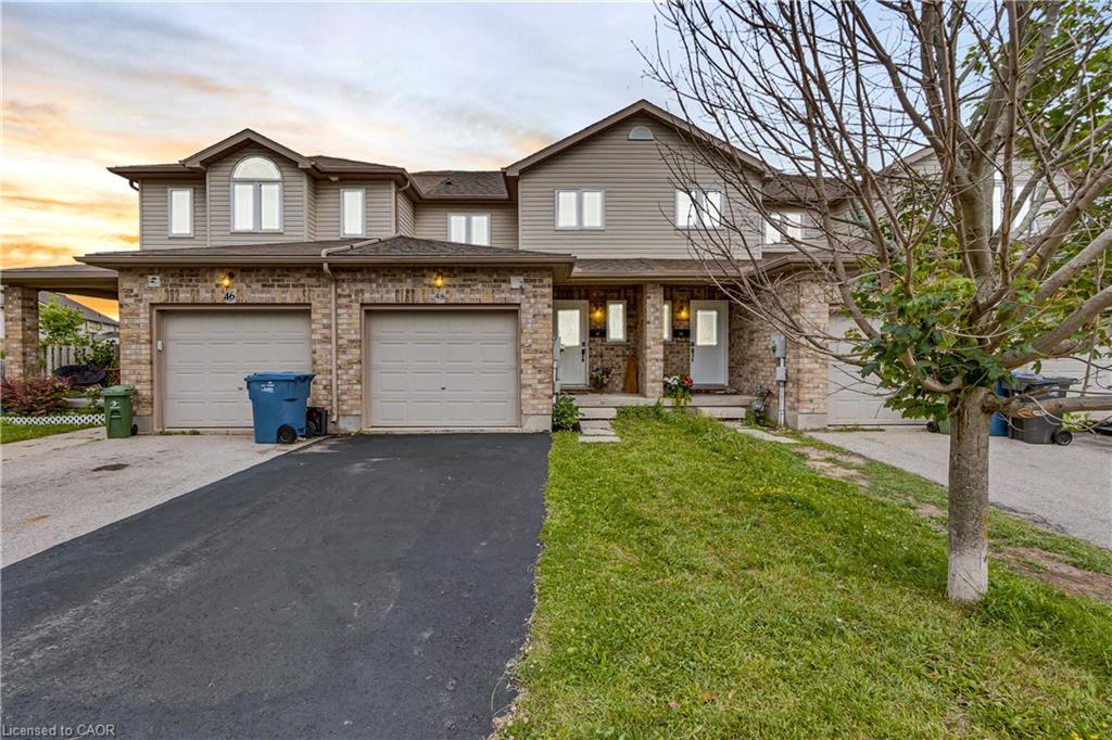 Exterior featuring brick and siding finishes, multiple windows, and an attached garage