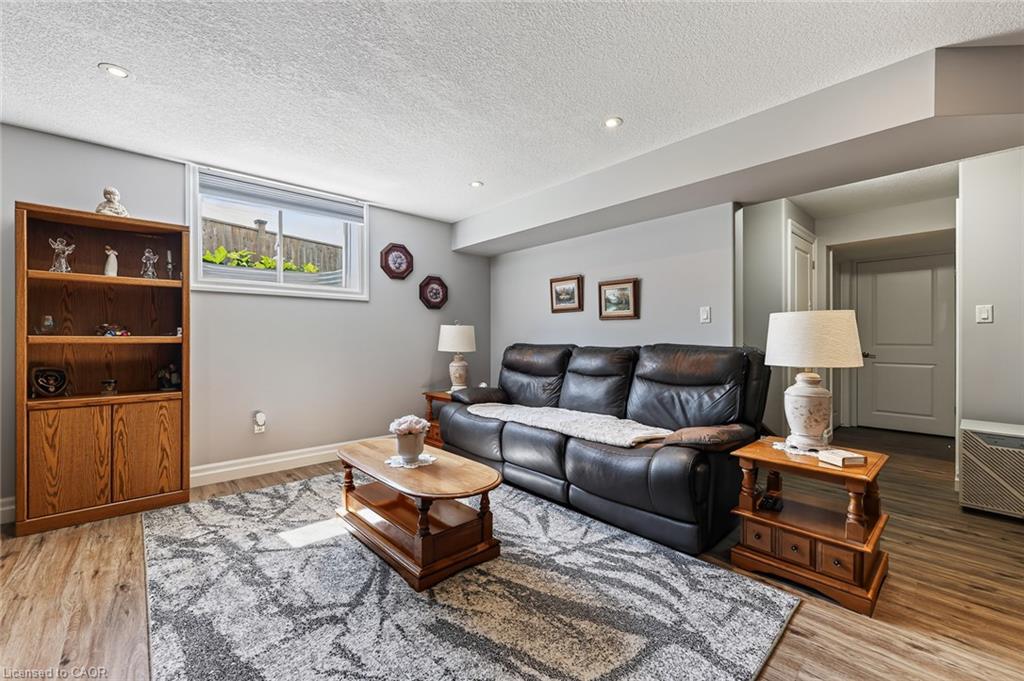 Living area featuring light gray walls, recessed lighting, and wood-finish flooring