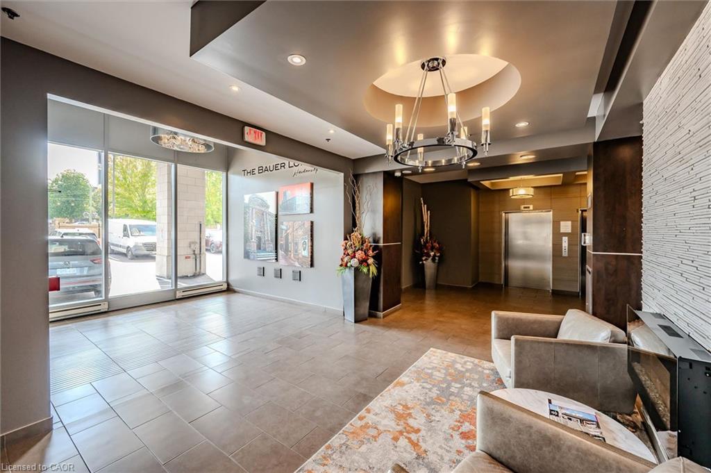 Lobby featuring large format floor tiling, recessed lighting, and a prominent chandelier