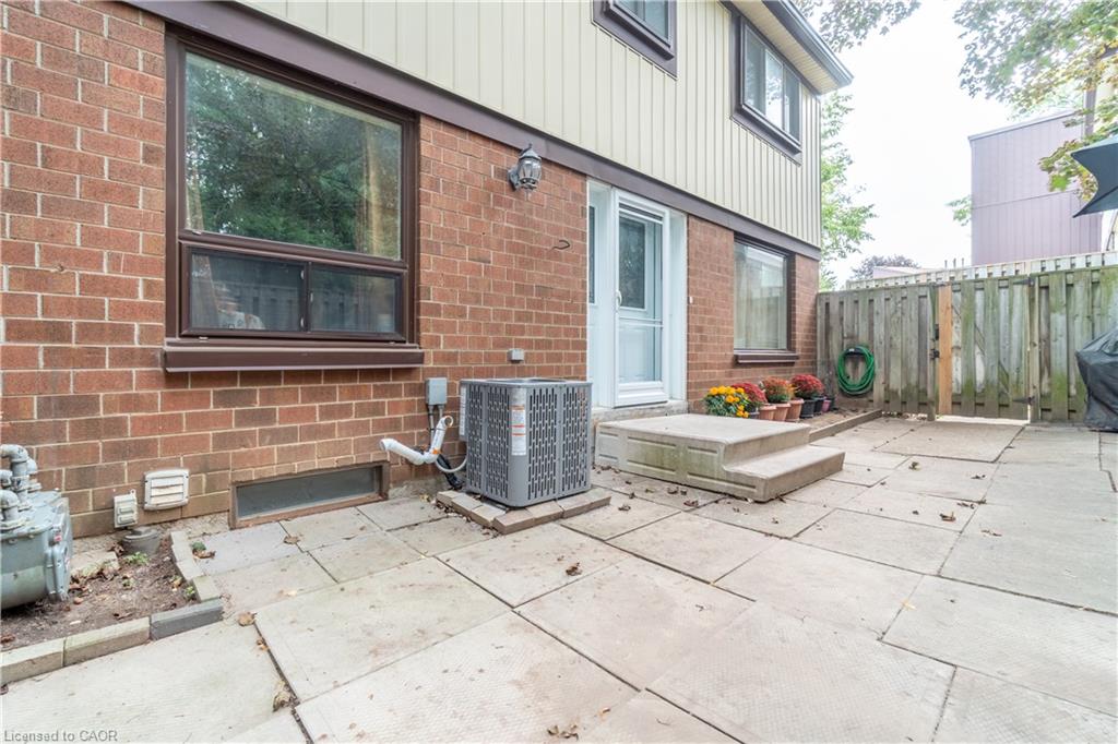 Brick and siding exterior with a paved patio