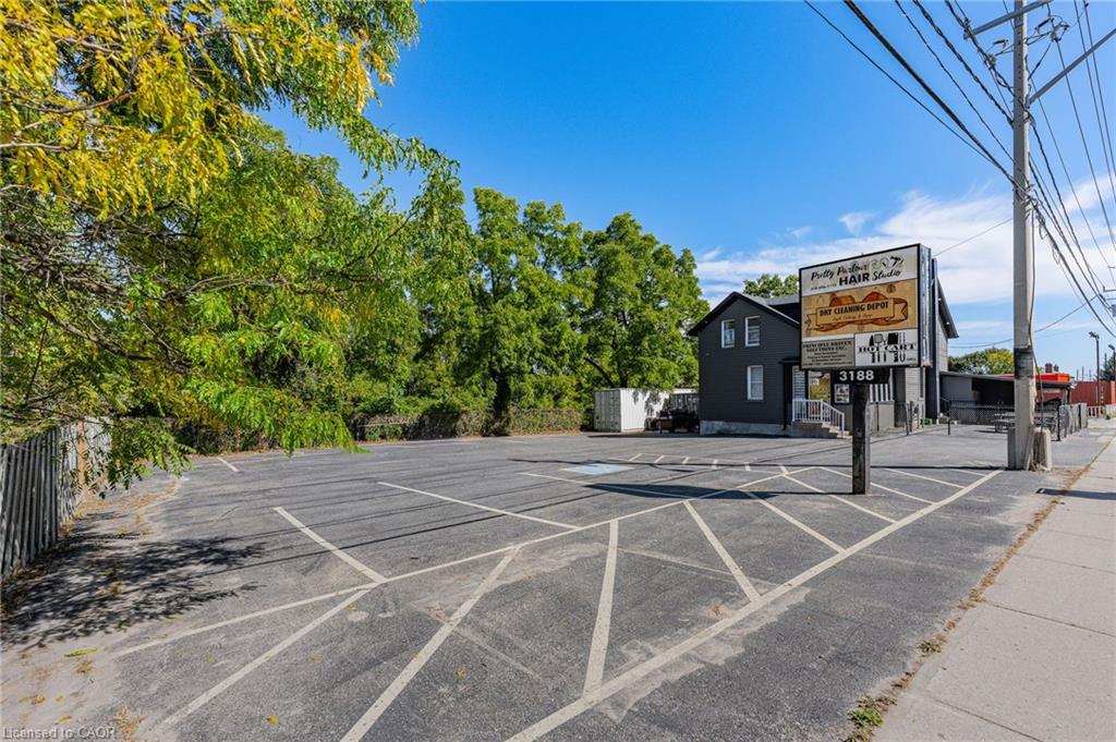 Asphalt parking lot with painted space dividers and a detached commercial sign
