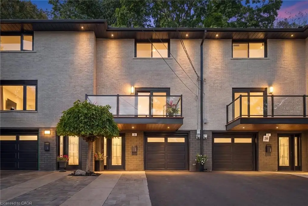 Modern townhouse exterior featuring light brick and dark trim