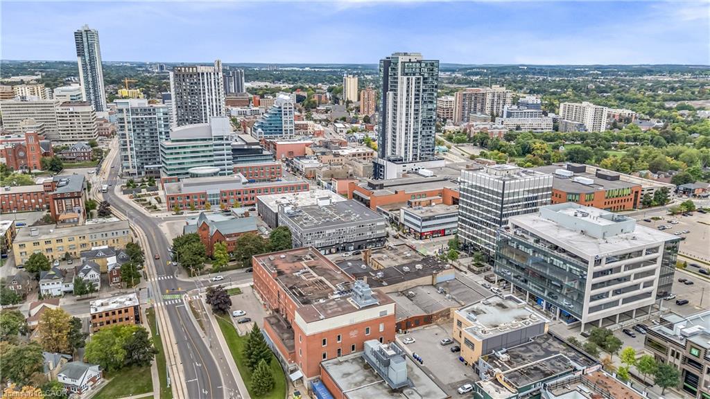 Aerial perspective showcasing a vibrant urban landscape with diverse architectural styles, including modern high-rise buildings and traditional brick structures