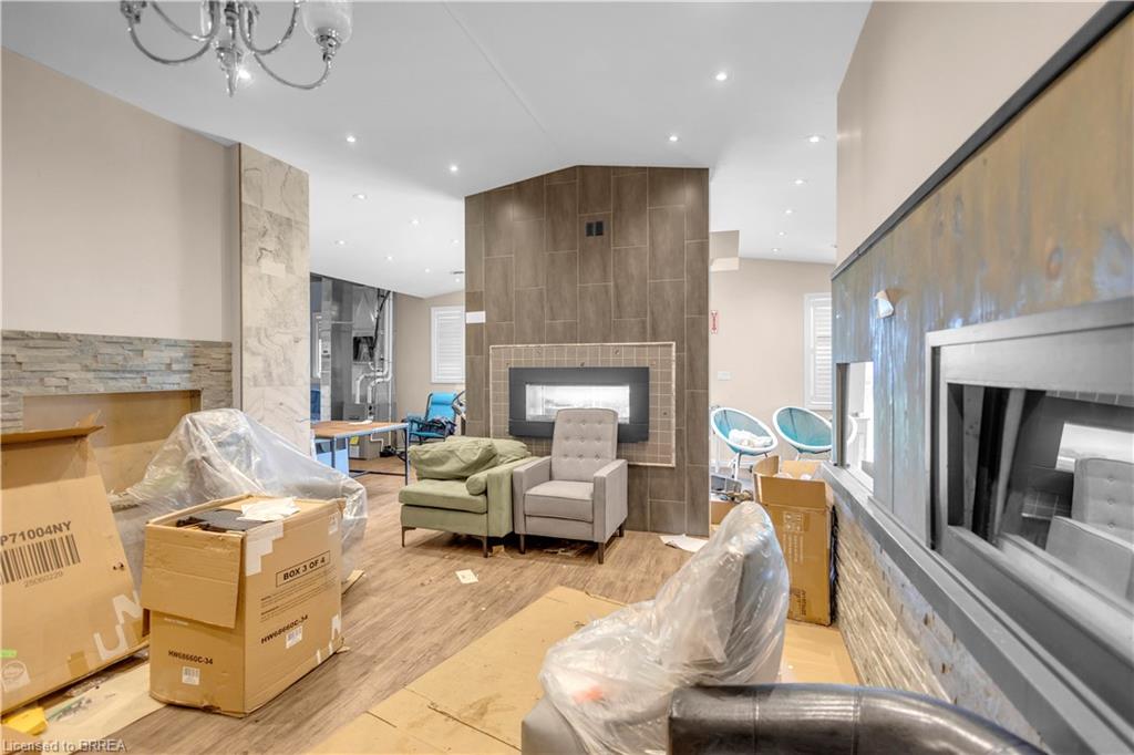 Spacious interior featuring wood-finish flooring, recessed lighting, and a modern chandelier