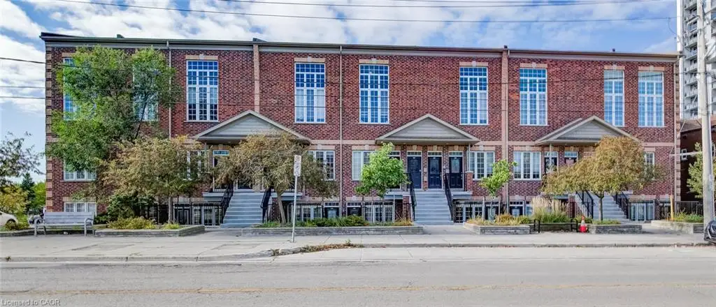 Brick facade townhomes with gabled entryways and large pane windows