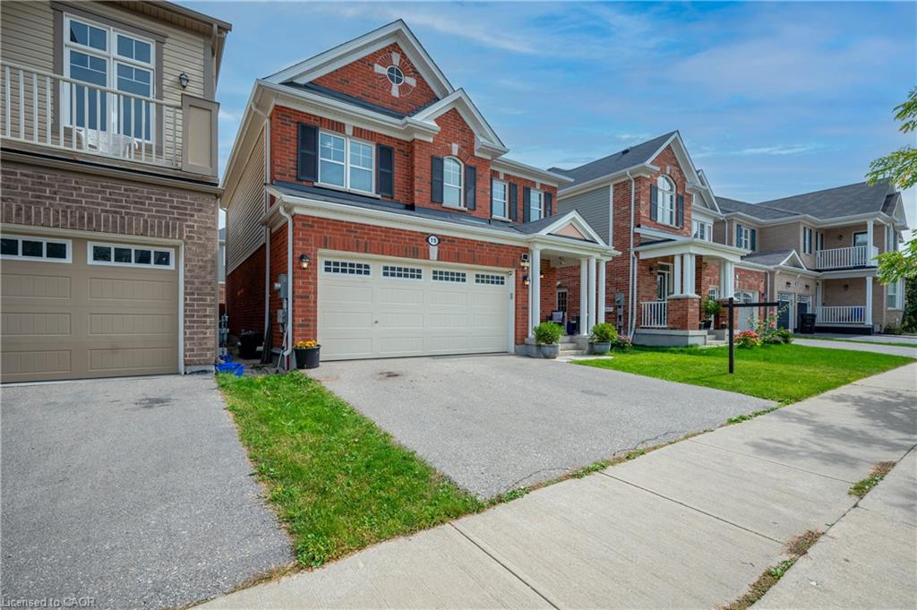 Brick and siding exterior with a covered front porch, two-car garage, and concrete driveway