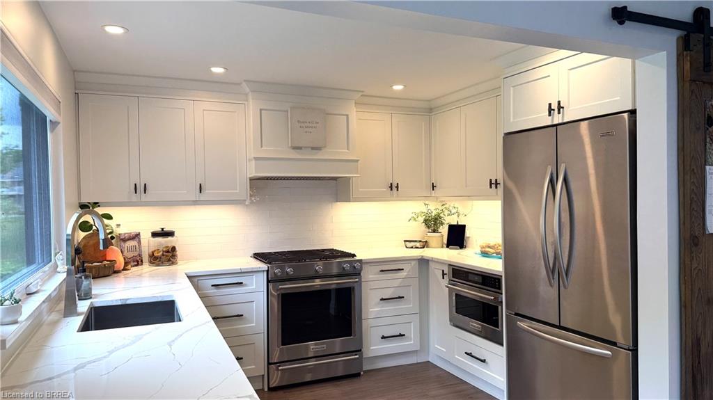 Quartz countertops LED pot lighting, SS appliances inc gas stove