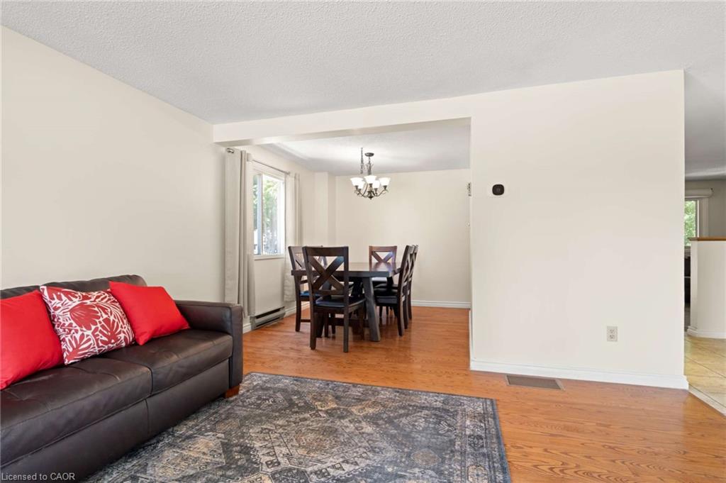 Hardwood-style flooring throughout, an open doorway, and a ceiling-mounted light fixture