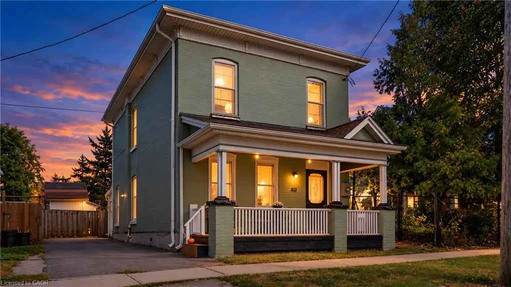 Two-story residence with a covered front porch featuring white railings
