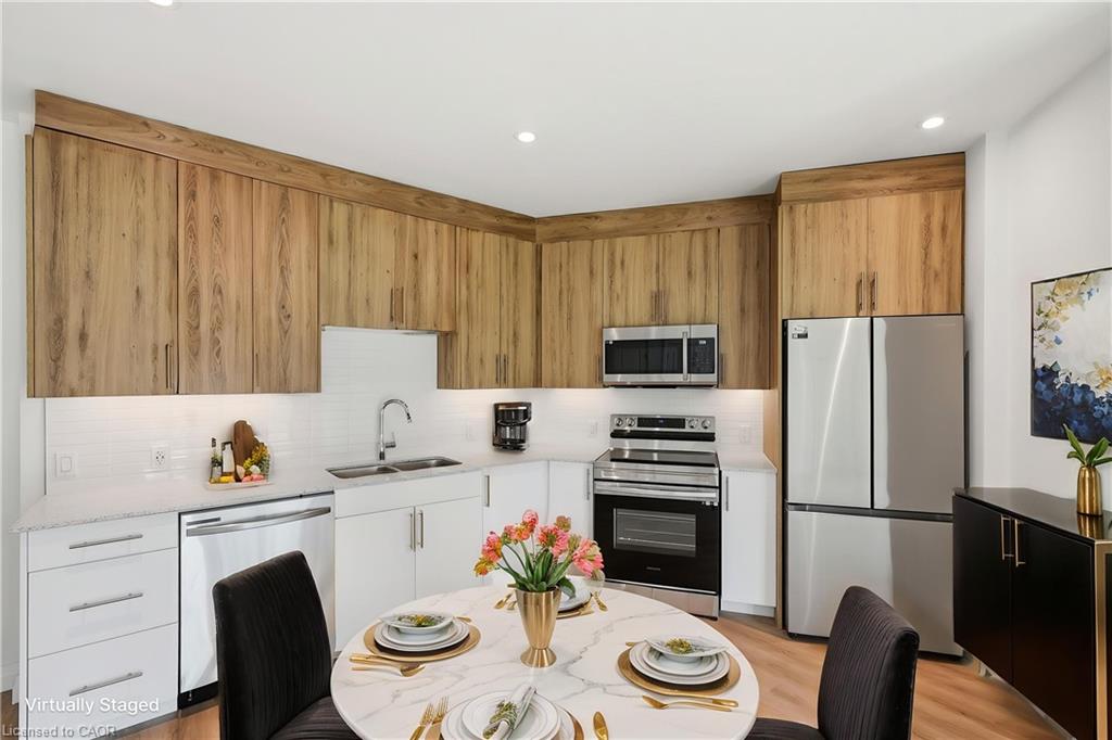 Modern kitchen featuring upper wood-finish cabinetry and lower white cabinetry
