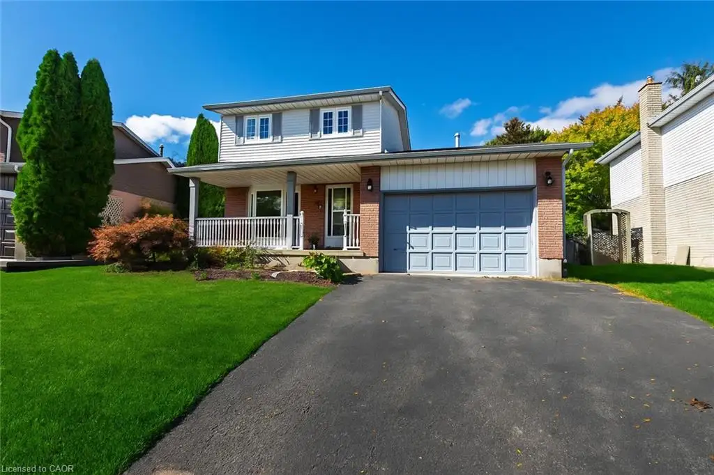 Two-story residence featuring brick and siding facade, an attached garage, and a covered front porch with white railings