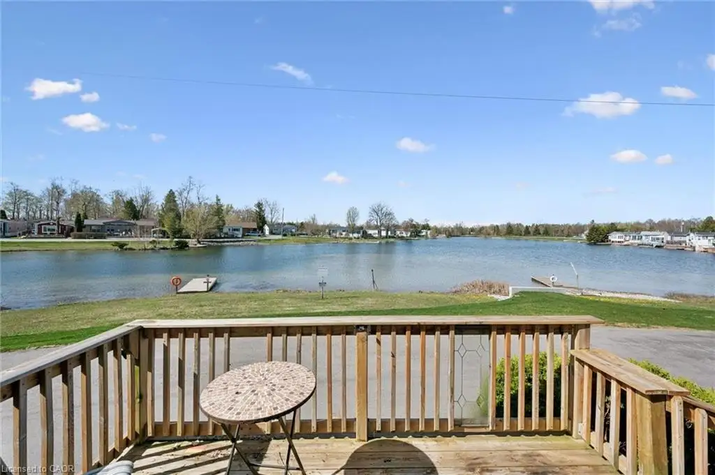 Elevated wood deck with slat railings overlooking a substantial body of water