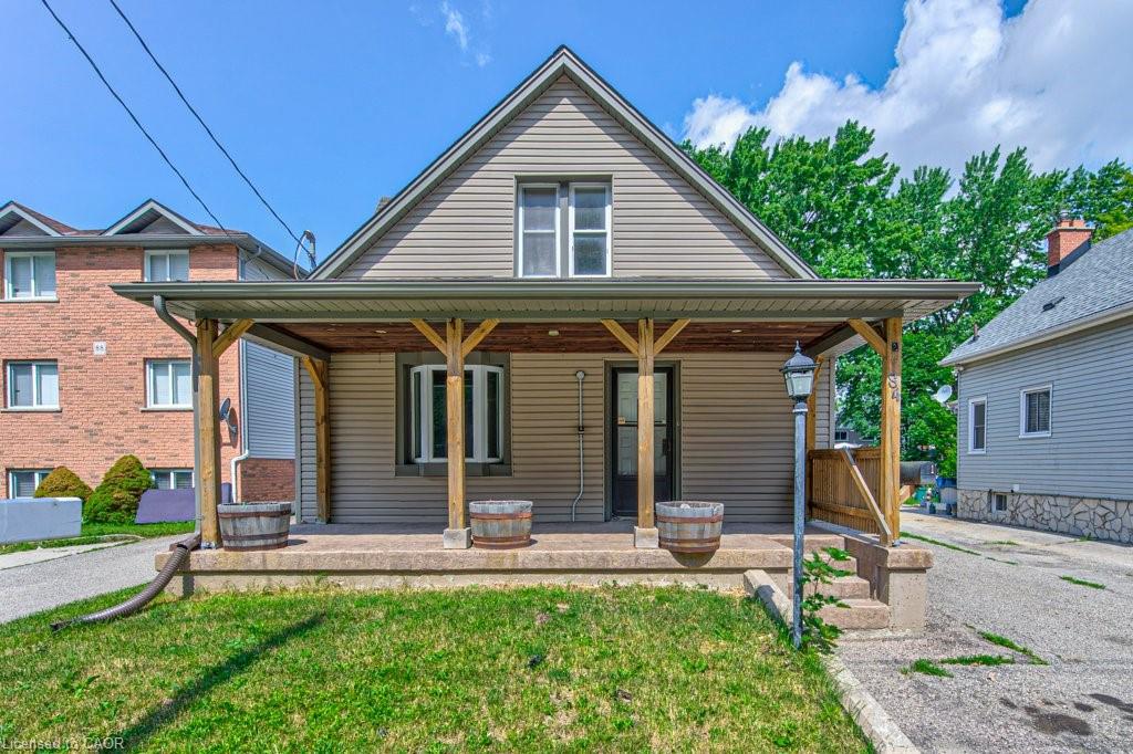 Gable-front home featuring horizontal siding and a covered front porch with exposed wood columns