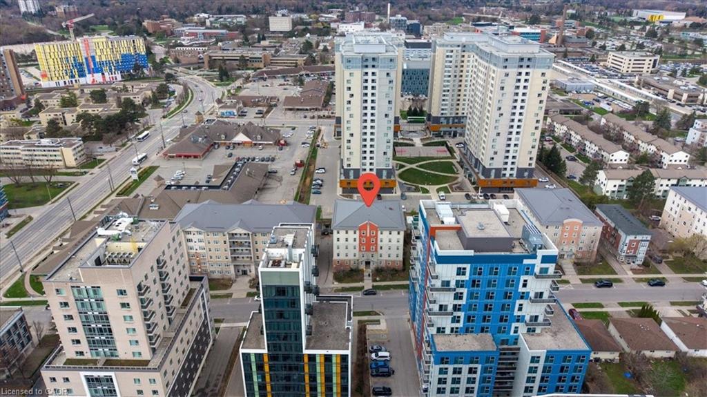 Aerial perspective showcasing a multi-story building prominently marked, surrounded by other residential and commercial structures
