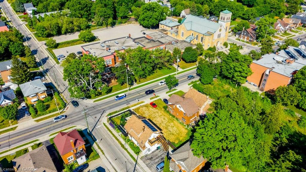 Aerial perspective showcasing a residential area with street intersections and abundant mature trees
