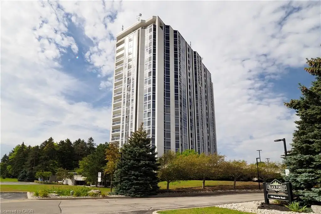High-rise residential building featuring a light-colored facade, numerous windows, and multiple private balconies
