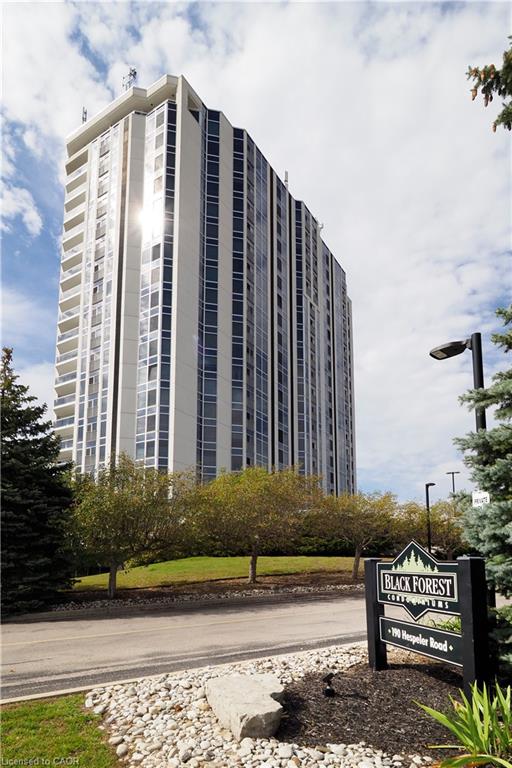 Modern high-rise condominium building with a prominent Black Forest Condominiums sign