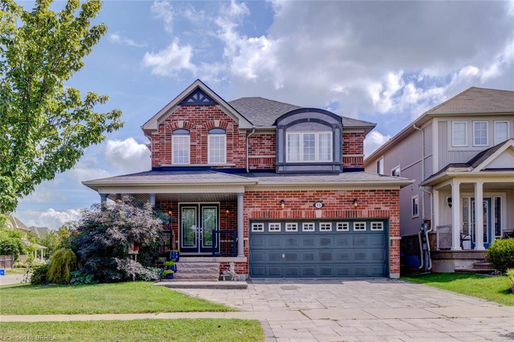 Brick exterior with an arched window dormer, covered porch, and double front doors