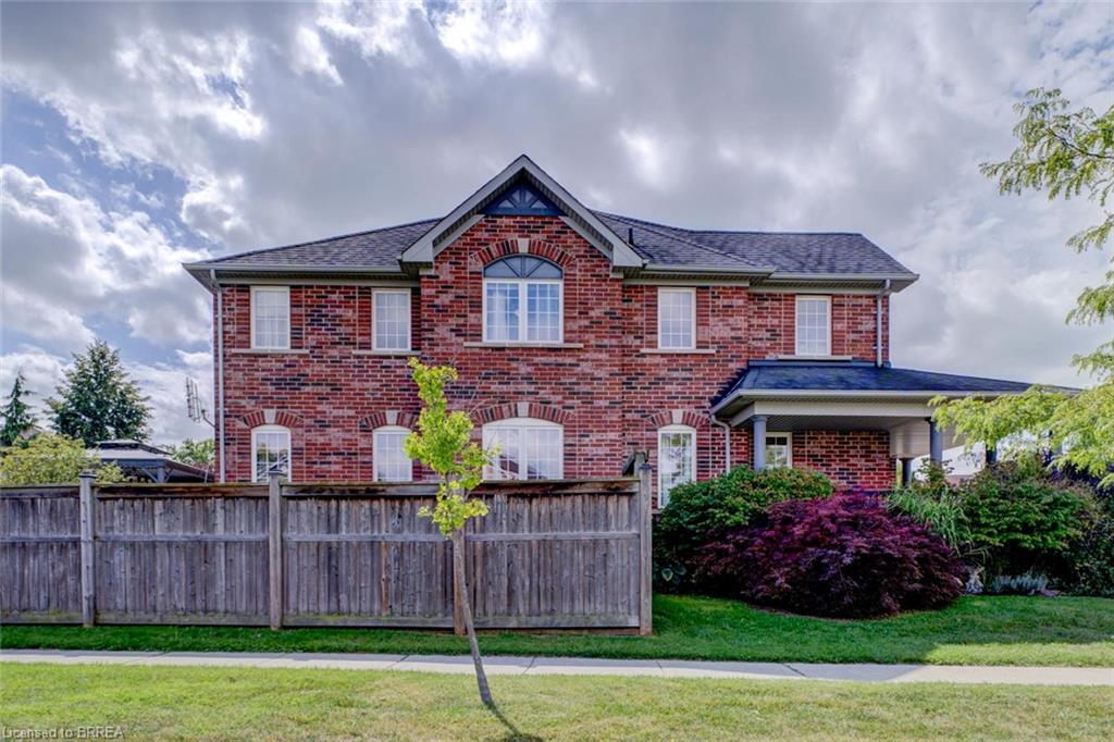 Brick exterior with a dark shingle roof and a covered porch supported by columns