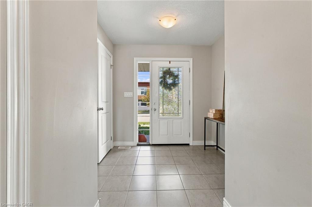 Entryway with neutral wall tones and tile flooring