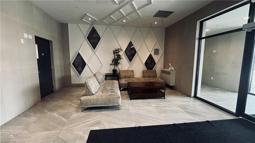 Tile flooring, decorative wall paneling, large glass entrance, recessed lighting