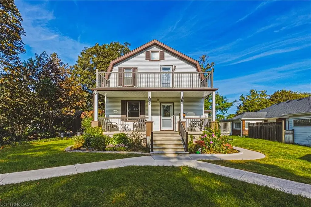 Two-story residence with a second-level balcony, covered porch, exterior siding, and a gabled roofline