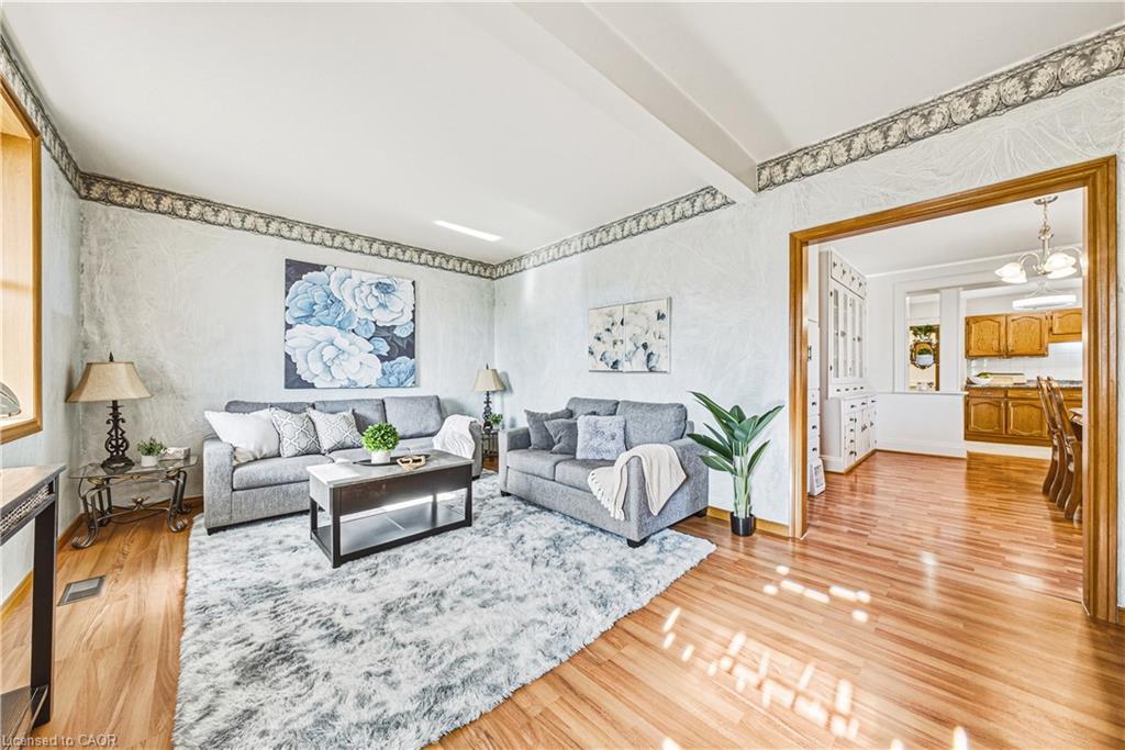 Wood-finish flooring throughout, featuring a broad entryway, and a built-in display cabinet