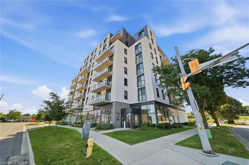 Multi-story building featuring a contemporary facade, numerous balconies with glass railings, and ground-level commercial spaces