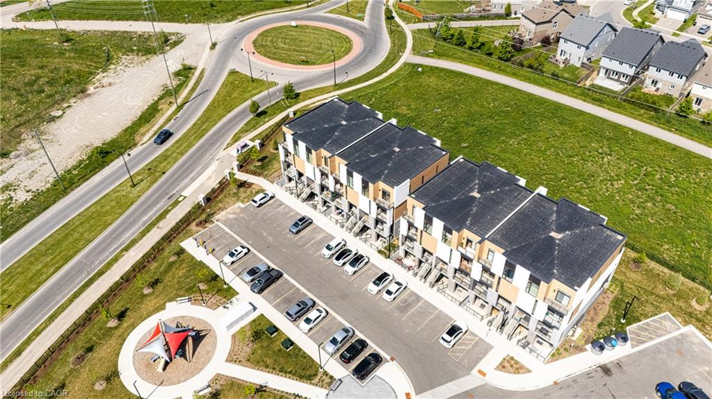 Modern townhome community featuring contemporary architecture with warm wood-tone facades, dark composite roofing, and clean geometric lines