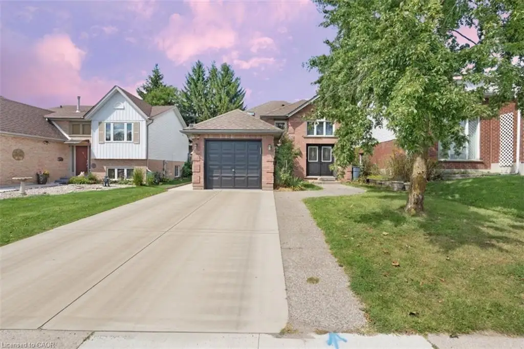 Brick exterior with white siding accents and a contrasting dark garage door