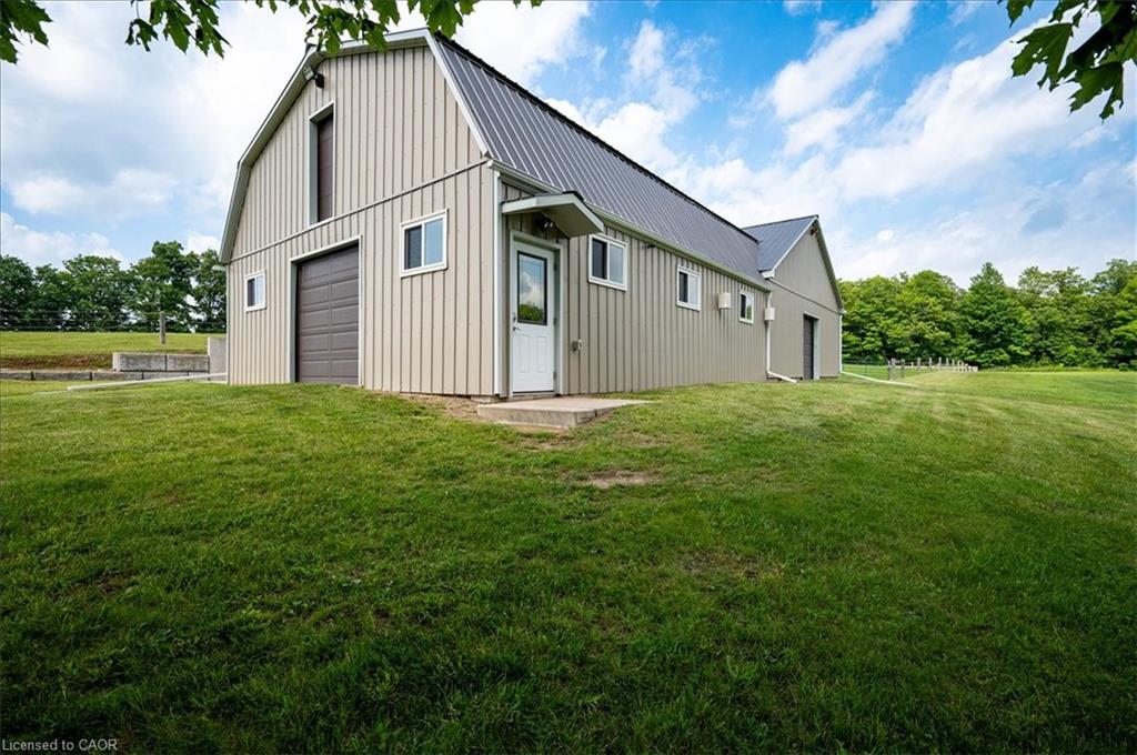 Barn-style structure with over 2800 sq feet of space, complete with horse stalls, tack room, and plenty of space for equiptment with hay loft above.