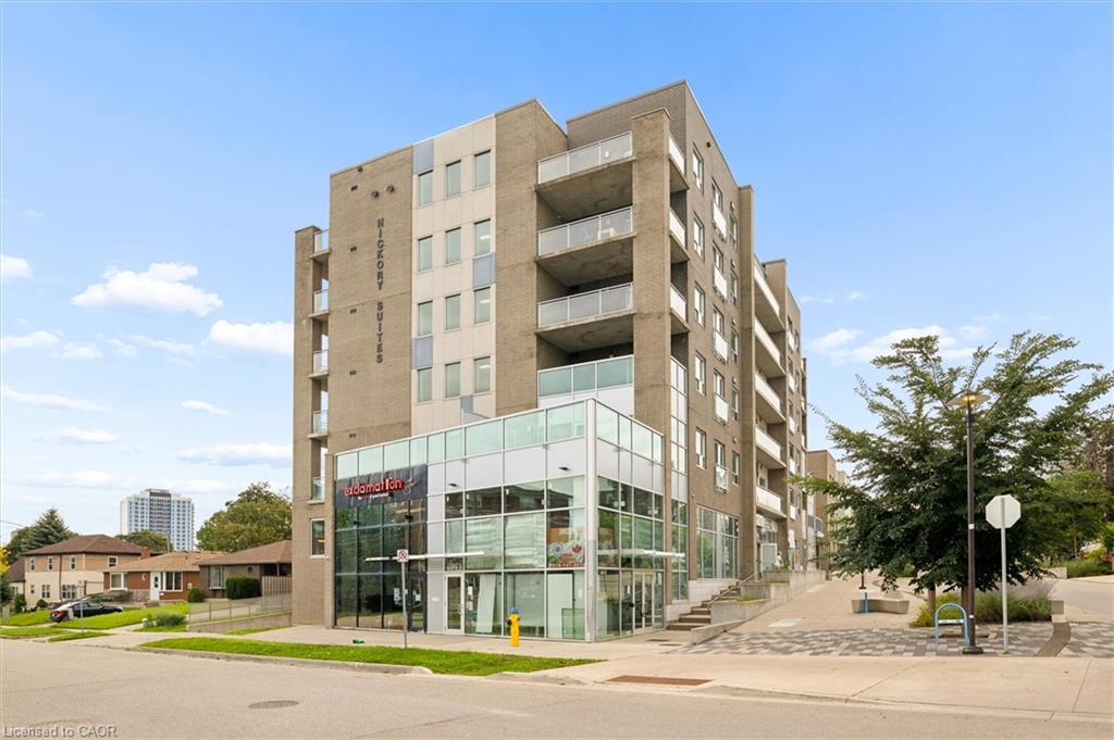 Modern multi-story building featuring a brick exterior and expansive ground-level commercial frontage