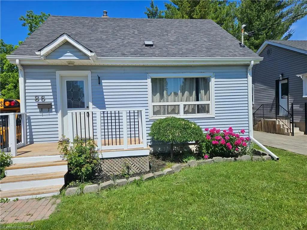 Light blue vinyl siding exterior with a gabled roofline and multiple windows providing natural light