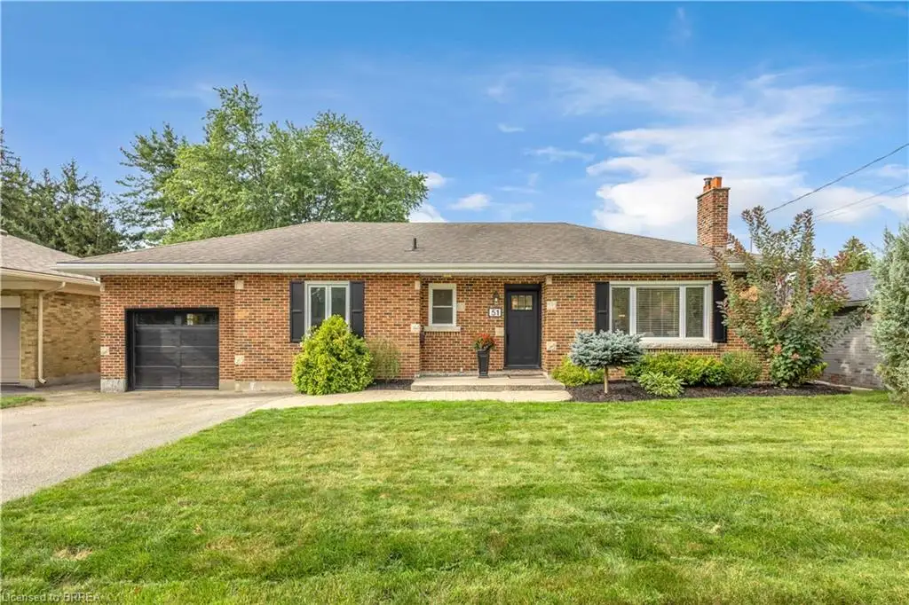 Brick exterior with dark shutters, attached single-car garage, concrete driveway, and front landscaping