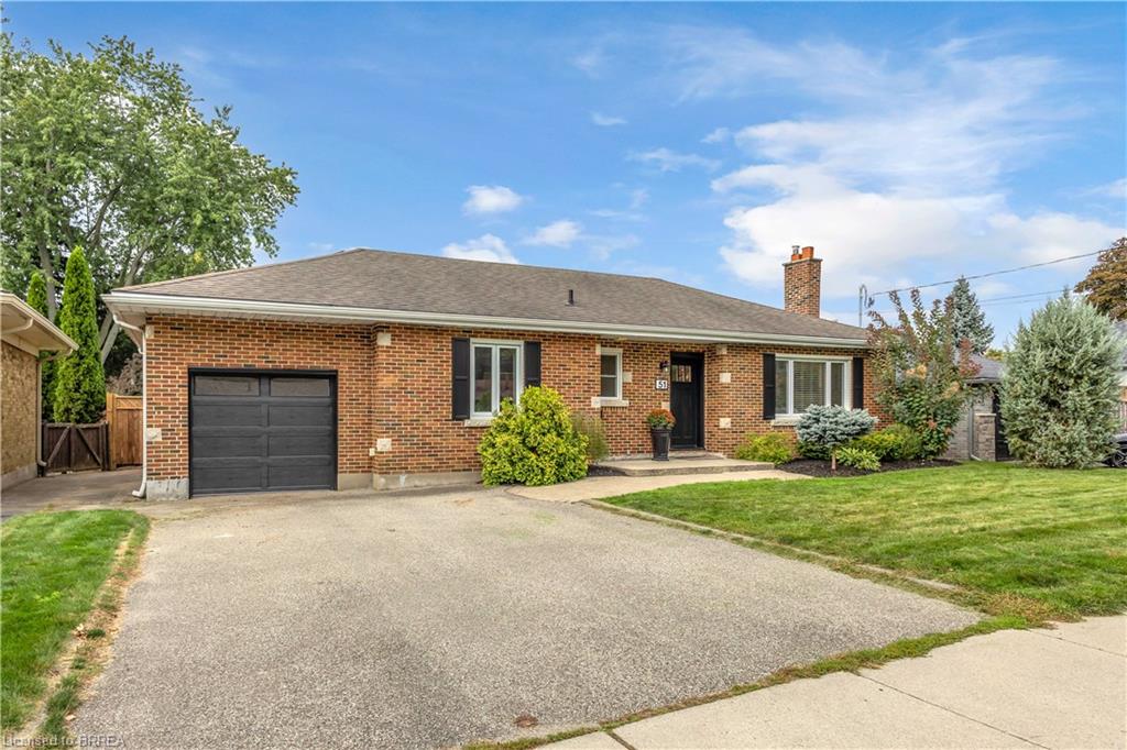 Brick exterior with a single-car garage and a paved driveway