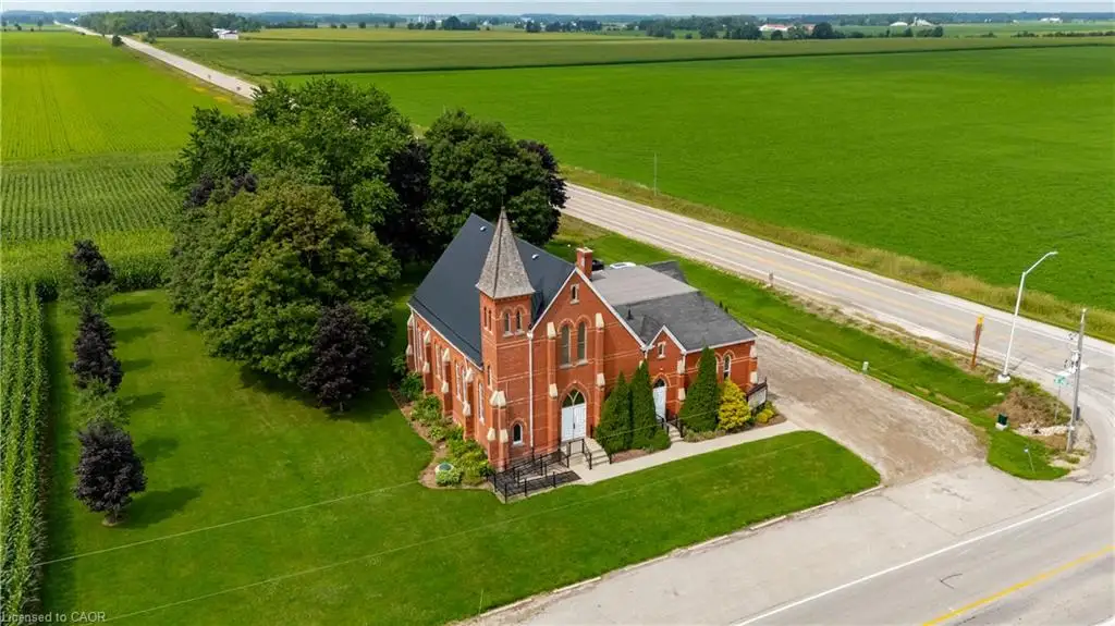 Red brick exterior featuring arched windows and a prominent steeple