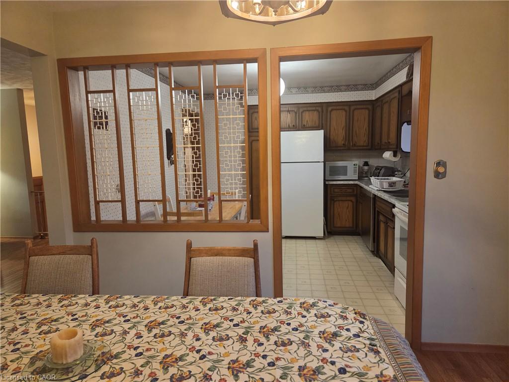 Wood-finish room divider with decorative screens