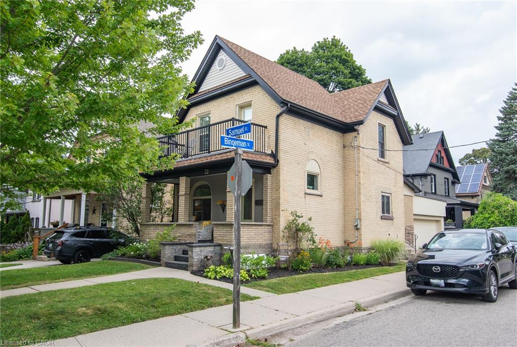 Two-story brick residence with dark trim and a gabled roofline
